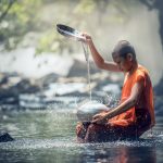 Buddhist boy in water