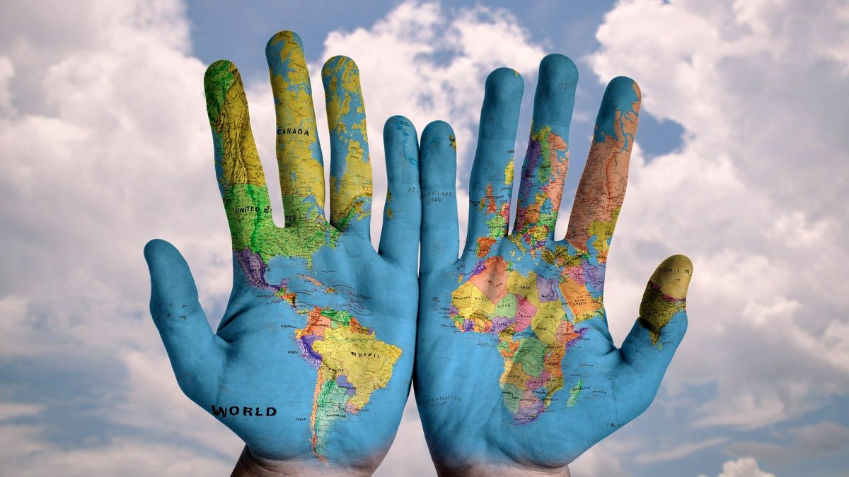 Hands with a world map on